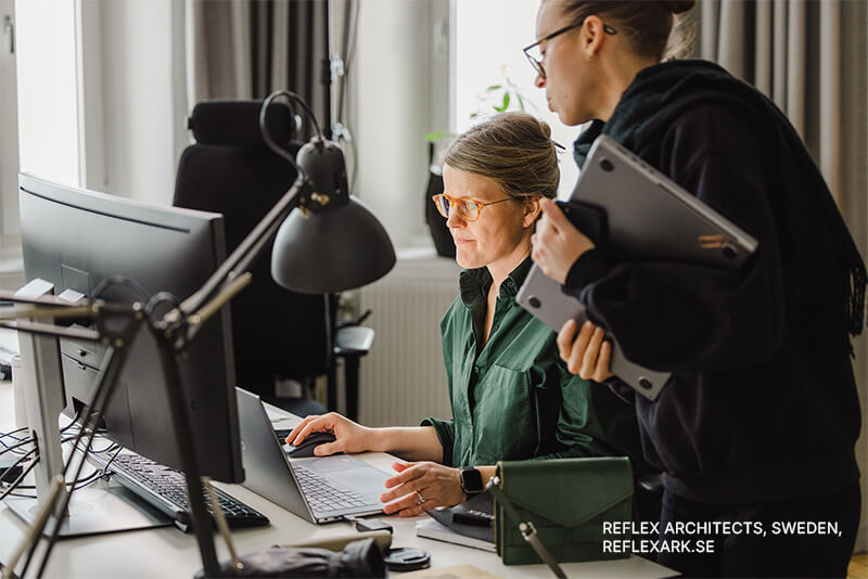 Two architects from Reflex Architects Sweden collaborating on Archicad at a workstation